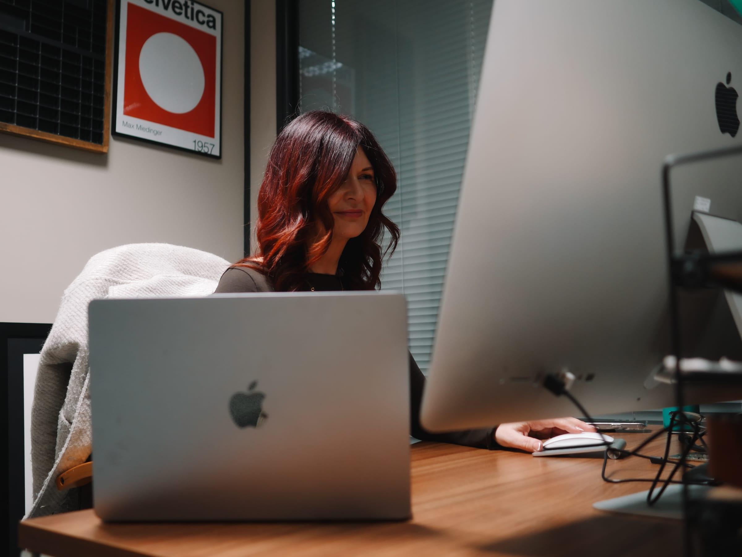 Brand designer working at a desk in the Merch Hive studio