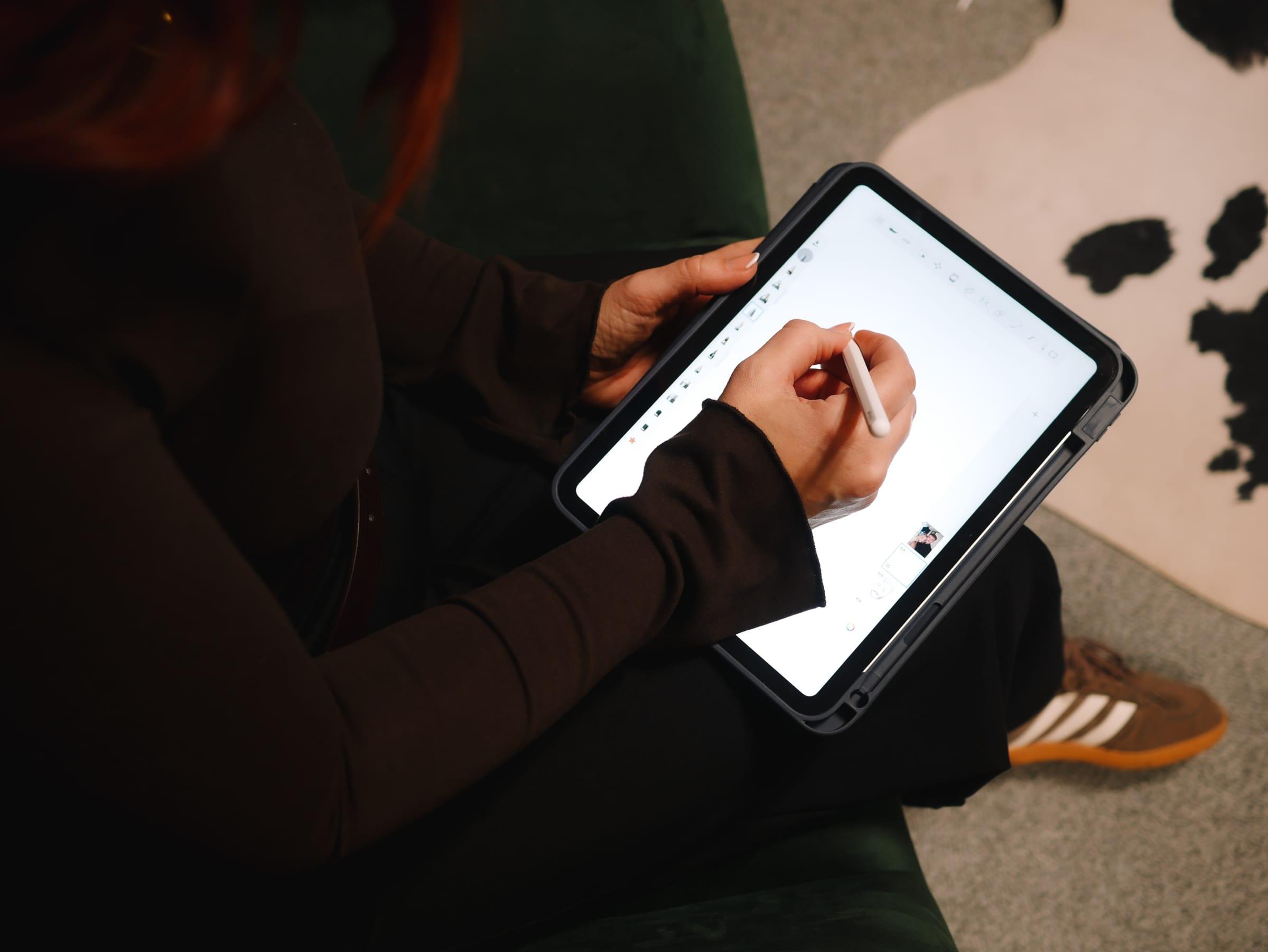 Designer sketching a logo on a tablet