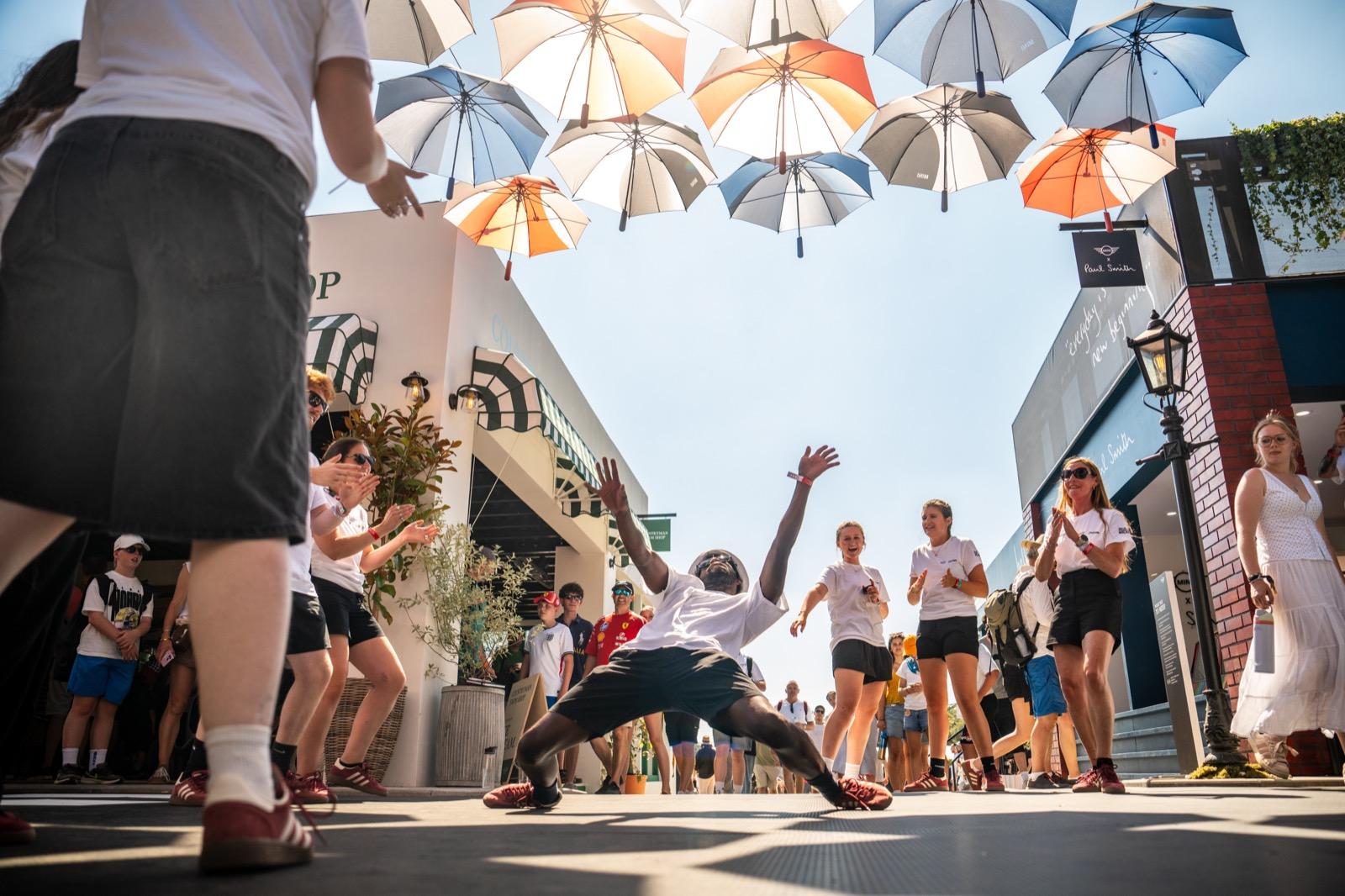 Dancers under the umbrella canopy at the MINI stand